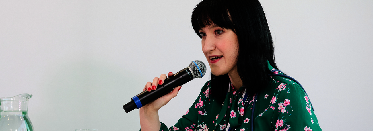 Malgorzata Grobelna, known as Margaret from the Zero Project team, speaking into a microphone during an event.