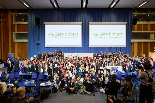 A group photo of all people who took part in the #ZeroCon24 Award Ceremony; a smiling group of people that are happy to celebrate together and be on this "Zero Project Family Photo"