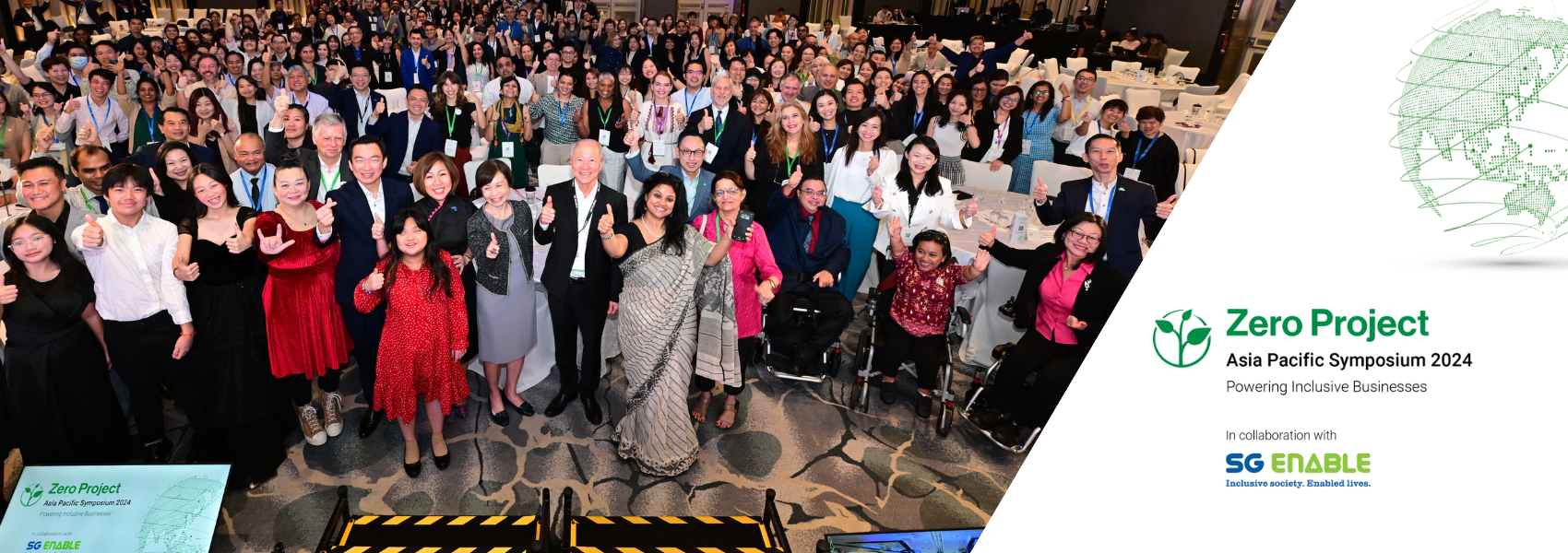 A group photo of all event participants - a large diverse group of people looking into the camera; guest of honor and representatives of SG Enable and the Zero Project stand front and center. Next to the photo, there is the event logo.