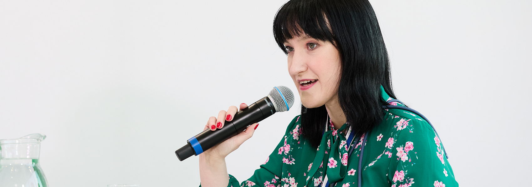 Malgorzata Grobelna, known as Margaret from the Zero Project team, speaking into a microphone during an event.